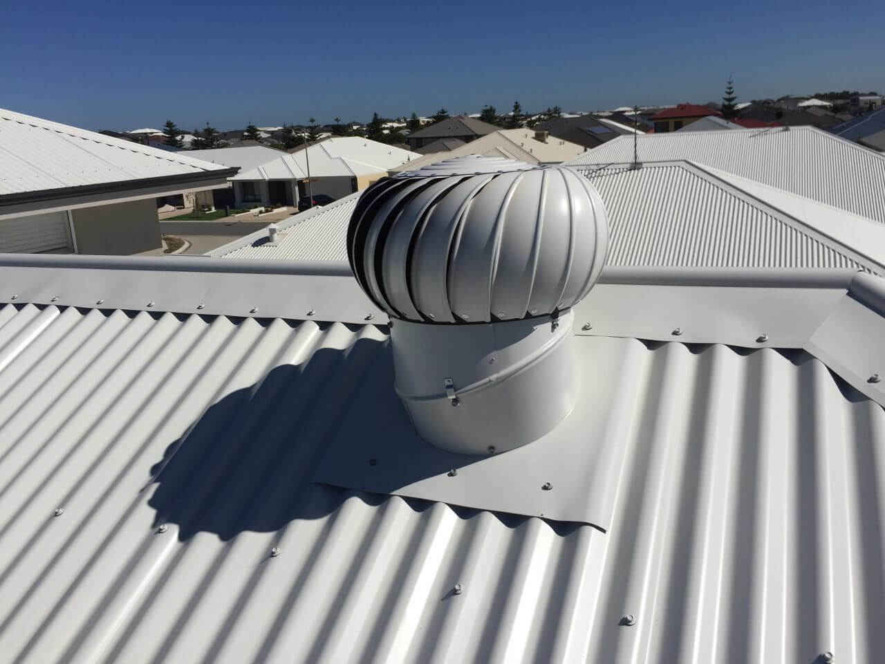 White whirlybird turbine ventilation installation on metal roof in Canberra by ShelterSafe White whirlybird installation Canberra - roof ventilation metal roof